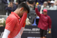 Serbia's Novak Djokovic wipes his face during the quarter final match against Denmark's Holger Rune at the Italian Open tennis tournament, in Rome, Wednesday, May 17, 2023. (AP Photo/Gregorio Borgia)