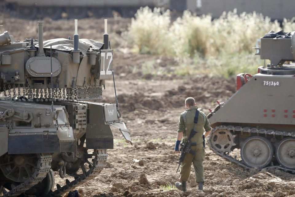 An Israeli soldier stands at a gathering point in Israel Gaza Border, Monday, May 6, 2019. The Israeli army on Monday lifted protective restrictions on residents in southern Israel, while the Hamas militant group's radio station in the Gaza Strip reported a cease-fire, signaling a deal had been reached to end the bloodiest fighting between the two sides since a 2014 war. (AP Photo/Ariel Schalit)