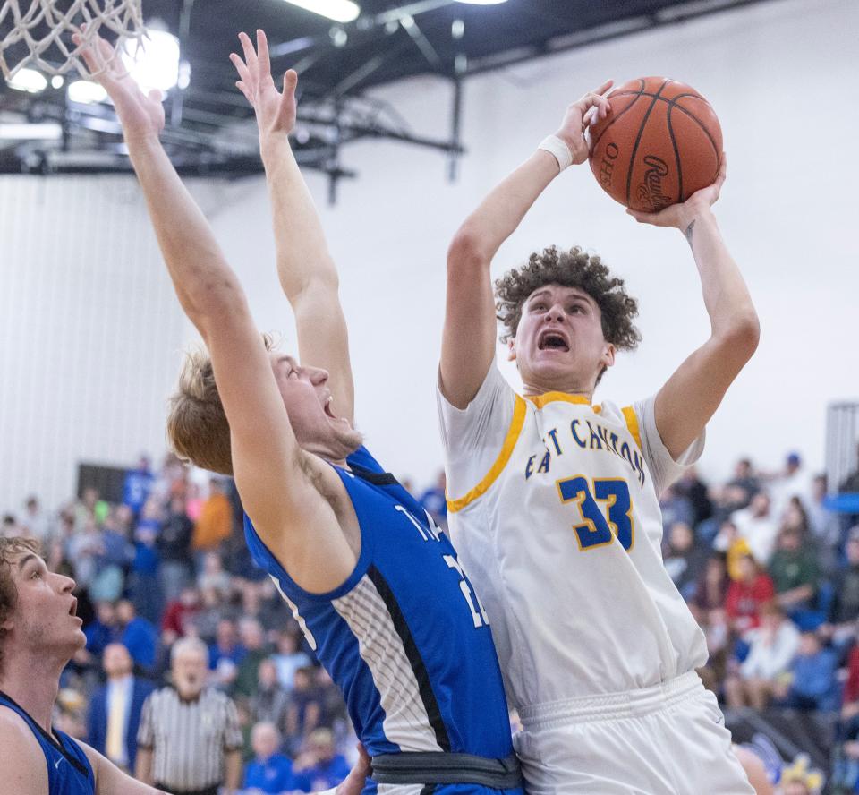 East Canton's Jaedyn McLeod goes to the hoop with pressure from Buckeye Trail's Donovan Geiger in the first half, Tuesday, Jan. 30, 2024.