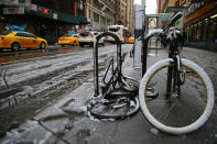 <p>Slushy snow covers streets and bikes in New York City on March 7, 2018. (Photo: Gordon Donovan/Yahoo News) </p>