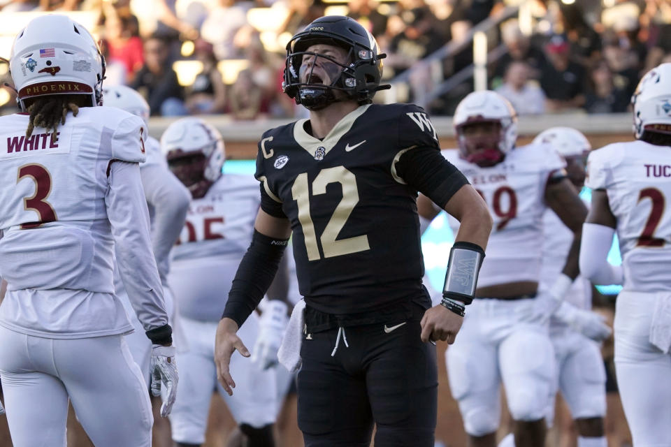Wake Forest quarterback Mitch Griffis (12) celebrates his touchdown pass against Elon during the first half of an NCAA college football game in Winston-Salem, N.C., Thursday, Aug. 31, 2023. (AP Photo/Chuck Burton)