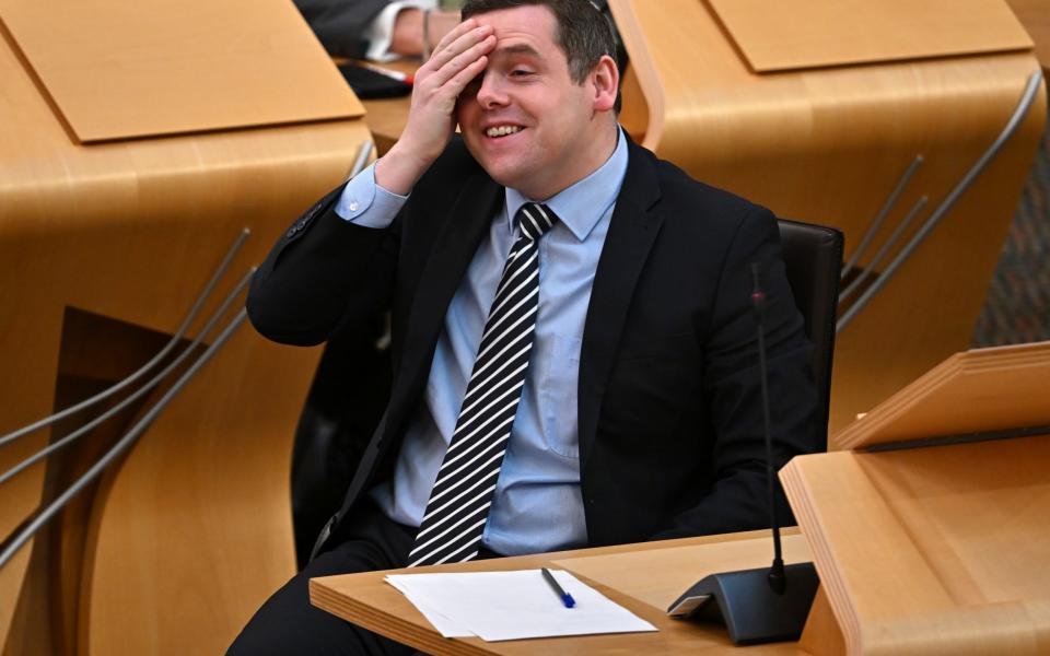Leader of the Scottish Conservatives Douglas Ross reacts during First Minister's Questions at Holyrood - Jeff J Mitchell/Getty Images
