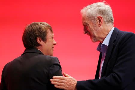 Britain's opposition Leader of the Labour Party Jeremy Corbyn touches shadow defence secretary Angela Eagle as she leaves stage at the annual Labour Party Conference in Brighton, southern Britain 28 September, 2015. REUTERS/Luke MacGregor