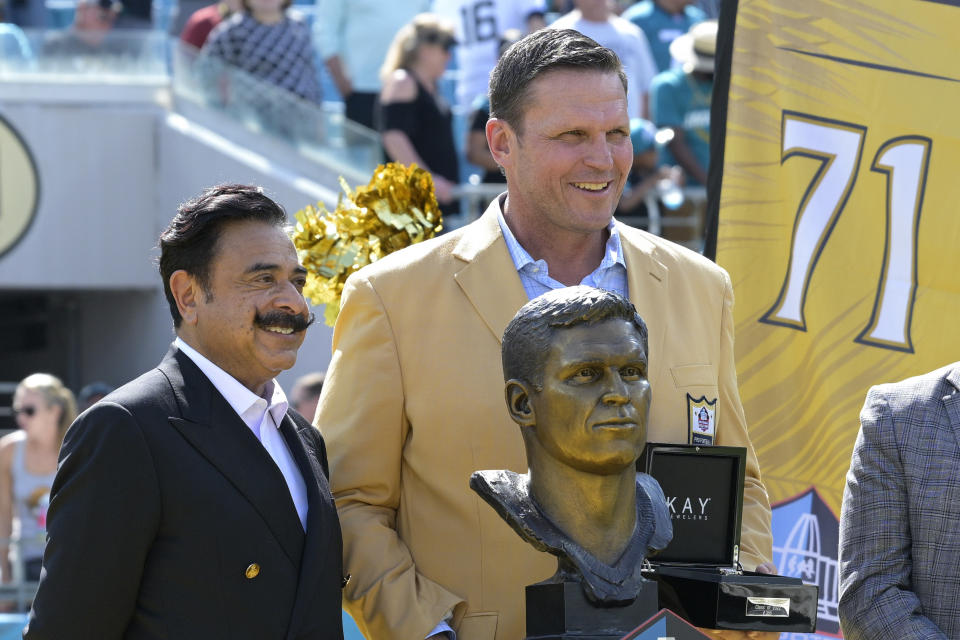 Former Jacksonville Jaguars lineman Tony Boselli, right, poses while being honored with owner Shad Khan, left, during halftime of an NFL football game against the Houston Texans in Jacksonville, Fla., Sunday, Oct. 9, 2022. (AP Photo/Phelan M. Ebenhack)