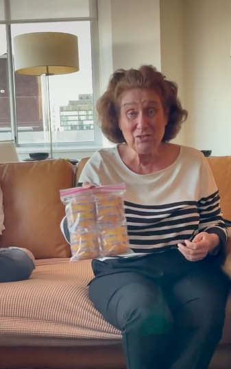 grandma sheila holding up a plastic bag filled with little pound cakes