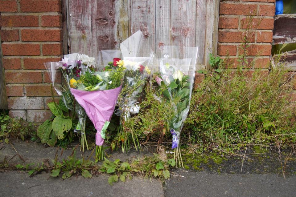 Flowers left outside the terraced house where Donald Patience’s body was found (Peter Byrne/PA)