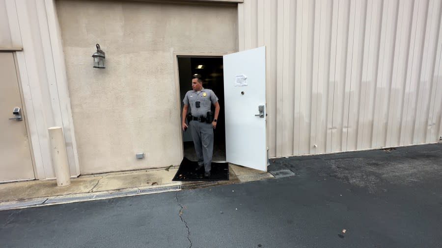 SC Highway Patrol Trooper Nicholson was standing in the doorway of the unsecured door at the back of the Clarendon County Magistrate’s Office on Nov. 15, 2023, after warning a Queen City News crew against bringing a news camera inside the public building. (WJZY Photo/Jody Barr)