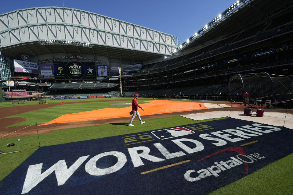 Players walk the field ahead of Game 1 of the baseball World Series between the Houston Astros and the Philadelphia Phillies on Thursday, Oct. 27, 2022, in Houston. Game 1 of the series starts Friday. (AP Photo/Eric Gay)