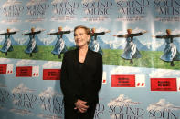 FILE - This Nov. 10, 2005 file photo shows actress Julie Andrews posing in front of posters for the 40th anniversary special edition DVD release party of the "Sound of Music" in New York. Andrews released a memoir, “Home Work: A Memoir of My Hollywood Years,” which hits shelves on Oct. 15, 2019. (AP Photo/Julie Jacobson, File)