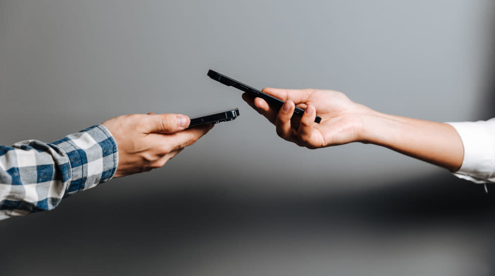  Two people using contactless mobile payments. 