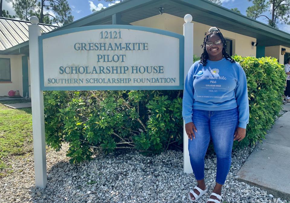 Danarria Stone stands in front of the Gresham-Kite Pilot Scholarship House at Florida Gulf Coast University.