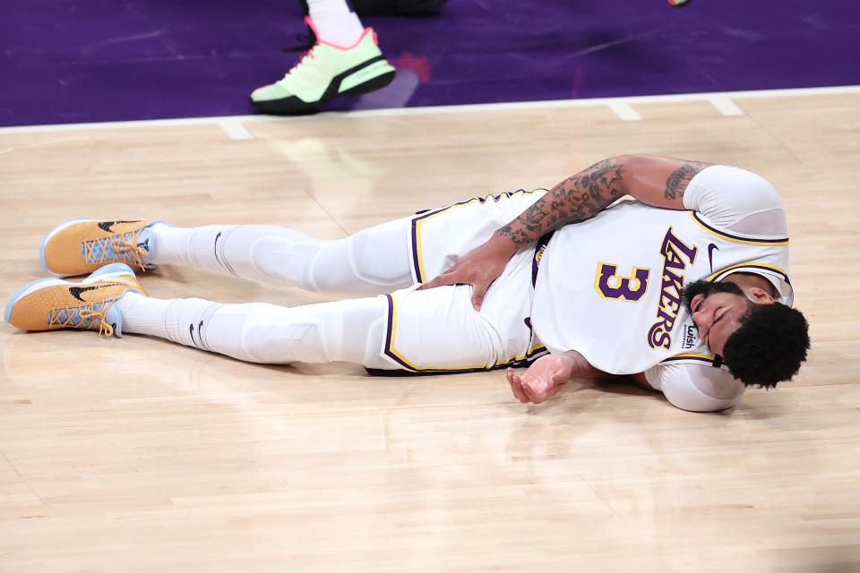 Anthony Davis grabs his thigh after falling during the first half of Game 4.