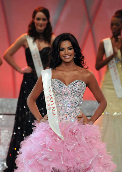 Miss Venezuela Ivian Lunasol Sarcos Colmenares (winner) lines up with the other contestants on stage.