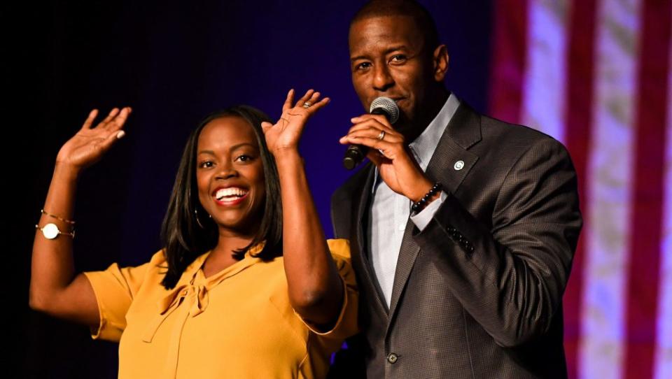 Andrew Gillum is joined by his wife R. Jai Gillum at a campaign rally in the CFE arena on November 3, 2018 in Orlando, Florida. (Photo by Jeff J Mitchell/Getty Images)