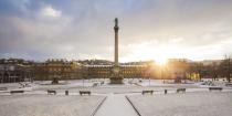 <p>The sun peeks through the snow-covered Schlossplatz, the largest square in Stuttgart-Mitte.</p>