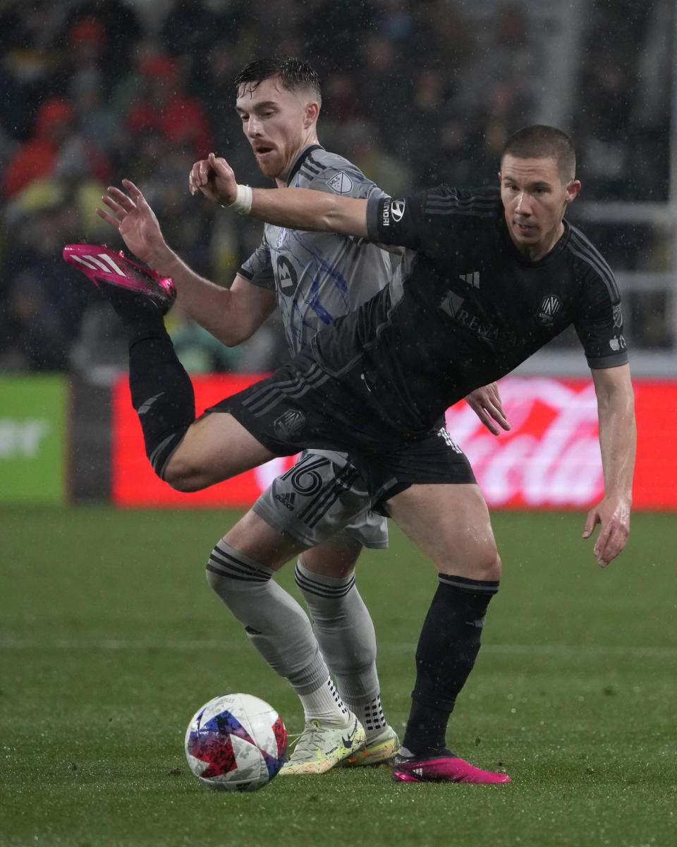 CF Montreal defender Joel Waterman, left, and Nashville SC midfielder Alex Muyl vie for the ball in the second half of an MLS soccer game, Saturday, March 11, 2023, in Nashville, Tenn. (AP Photo/Mark Humphrey)