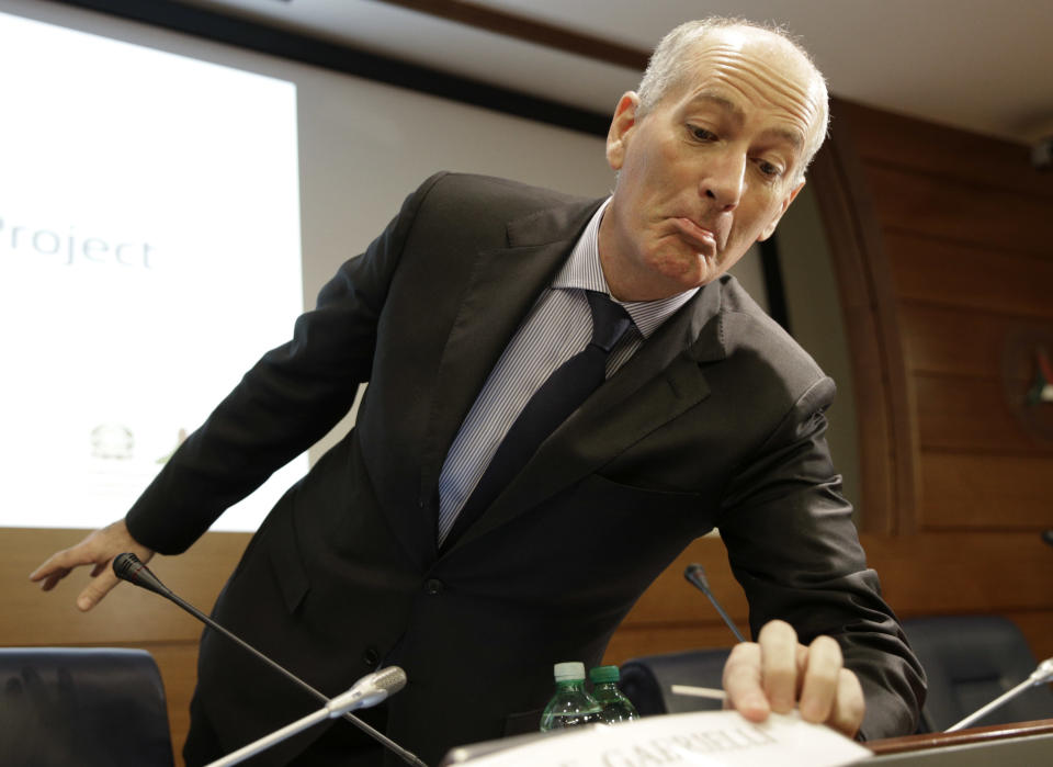 Italian Civil Protection head Franco Gabrielli checks his name tag during a press conference to present the Costa Concordia recovery project, in Rome, Friday, Jan. 10, 2014. Rome, Friday, Jan. 10, 2014. During a press conference in Rome on Friday, Jan. 10, 2014, officials announced the shipwrecked Costa Concordia will be removed from its watery graveyard off Tuscany in June and taken to a port to be dismantled, the final phase of an unprecedented 600 million-euro ($817 million) salvage effort. The announcement came just days before the second anniversary of the Jan. 13, 2012, grounding that killed 32 people. (AP Photo/Andrew Medichini)