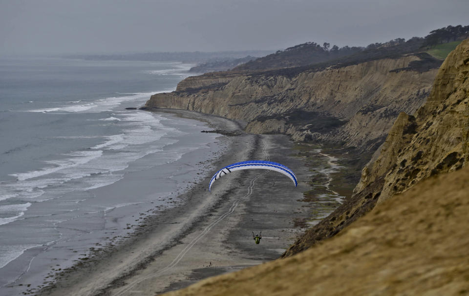 This Oct. 3, 2013 photo shows a lone glider sailing north over the rugged cliffs of the Southern California coast in San Diego. The glider port is open to the public and offers fantastic views and refreshments. The nation’s eighth-largest city has matured from its “Fast Times at Ridgemont High” surf days. Today it boasts a burgeoning international art scene, thriving farm-to-table food movement, and a booming bio-tech industry. (AP Photo/Lenny Ignelzi)