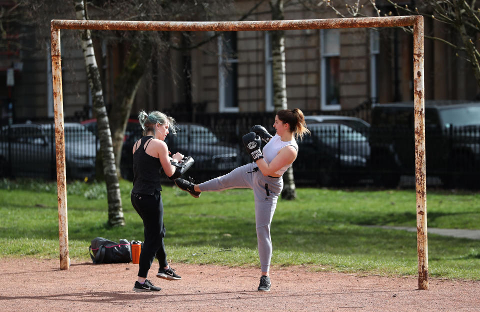 Clementine Sage(L) and Lucy Paterson perform Muay Thai in Kevingrove Park in Glasgow as the UK continues in lockdown to help curb the spread of the coronavirus.