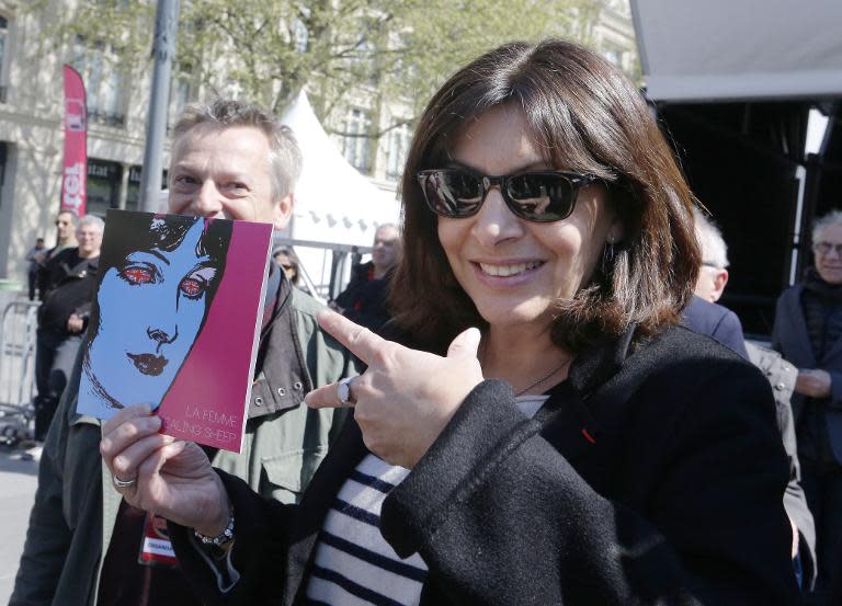 Mayor of Paris Anne Hidalgo holds an album by French band "Stealing Sheep" and French band "La Femme" on "Disquaire Day" (Record Store Day) on the Place de la Republique in Paris on April 18, 2015