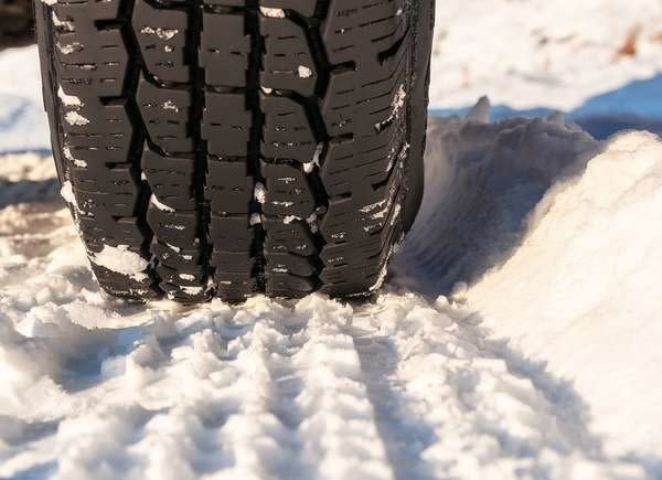 Snow tire treads on a snowy surface.
