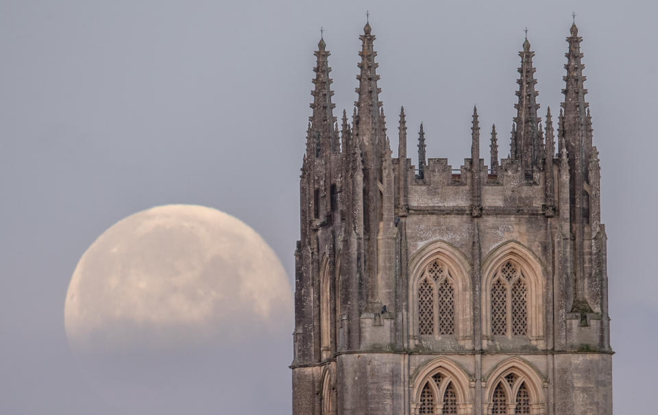 STRATTON-ON-THE-FOSSE, UNITED KINGDOM - FEBRUARY 01:  A Super Blue Blood Moon sets behind Downside Abbey, a Benedictine monastery, in Stratton-on-the-Fosse on February 1, 2018 in Somerset, England. Last night's Super Blue Blood Moon was the result of three lunar phenomena happening all at once: not only is it the second full moon in January, but the moon will also be close to its nearest point to Earth on its orbit, and be totally eclipsed by the Earth's shadow. The last time these events coincided was in 1866, 152 years ago. (Photo by Matt Cardy/Getty Images)