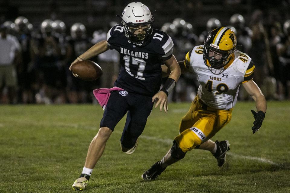 West York quarterback Isaac Roberts is pursued by Red Lion's Isaac Earnest. Red Lion defeated West York, 45-32, in football at West York Area High School, Friday, September 2, 2022.