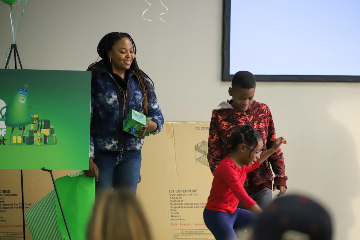 Angel Charma and her two children are recipients of Cricket Wireless' 12 Days of Cricket, in conjunction with the Boys and Girls Clubs of America. Her's and two other families in Sioux Falls were given $5,000 in gifts on Tuesday, Nov. 29.