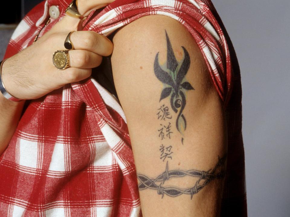 A tattoo design on a person's upper bicep with Chinese characters.