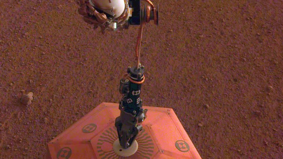 InSight's white robotic arm and black hand-like gripper placed the first seismometer on another planet on December 19, 2018. - NASA/JPL-Caltech