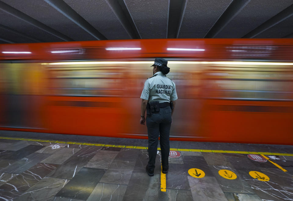 A member of the Mexican National Guard stands guard at a city's subway station in Mexico City,bThursday, Jan. 12, 2023. The mayor of Mexico City says that more the 6 thousand National Guard officers will be posted in the city's subway system after a series of accidents that officials say could be due to sabotage. (AP Photo/Fernando Llano)