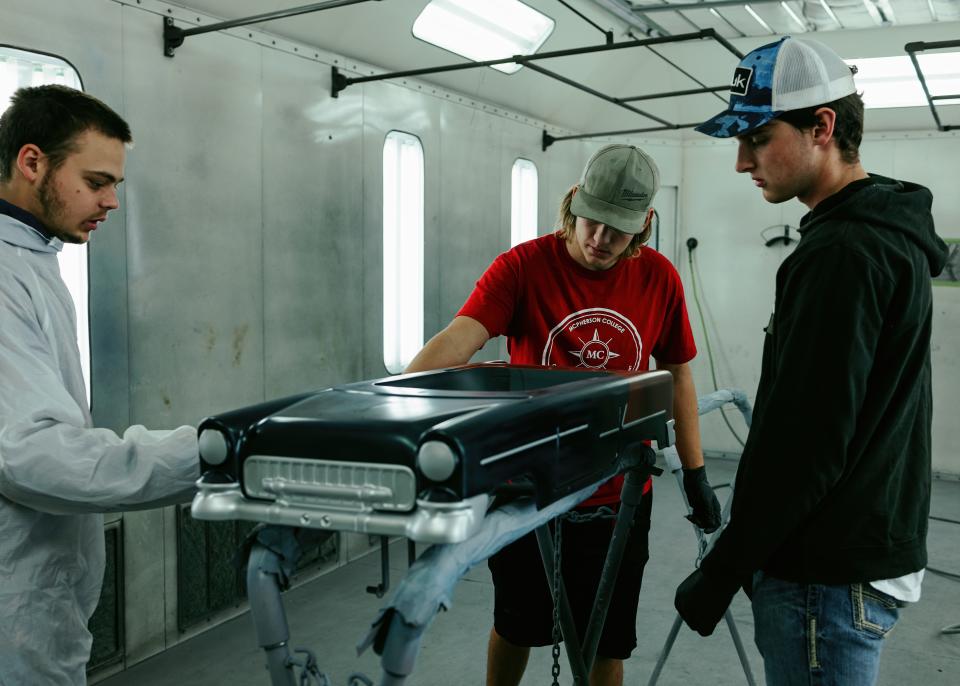 McPherson College automotive restoration students prepare a model car for paint job.