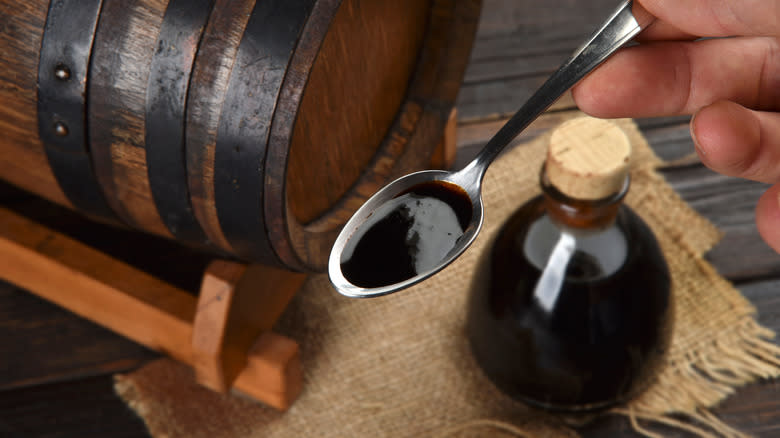bottle of balsamic and barrel with spoon