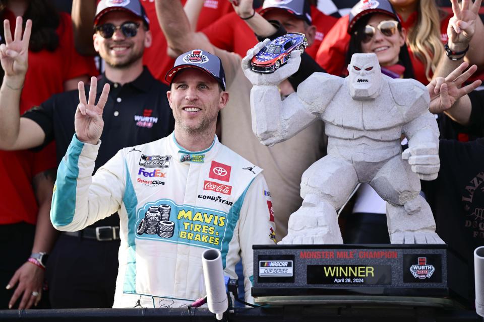 Denny Hamlin, front left, celebrates in Victory Lane after winning a NASCAR Cup Series auto race at Dover Motor Speedway, Sunday, April 28, 2024, in Dover, Del. (AP Photo/Derik Hamilton)