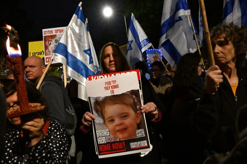 A woman holds a poster of a hostage held in Gaza by Hamas at a protest calling for the resignation of Israeli Prime Minister Benjamin Netanyahu outside his residence in Jerusalem on Saturday, November 25, 2023. Demonstrators blame Netanyahu for failing to keep the people of the Gaza border communities secure from the October 7 Hamas massacre. Photo by Debbie Hill/ UPI
