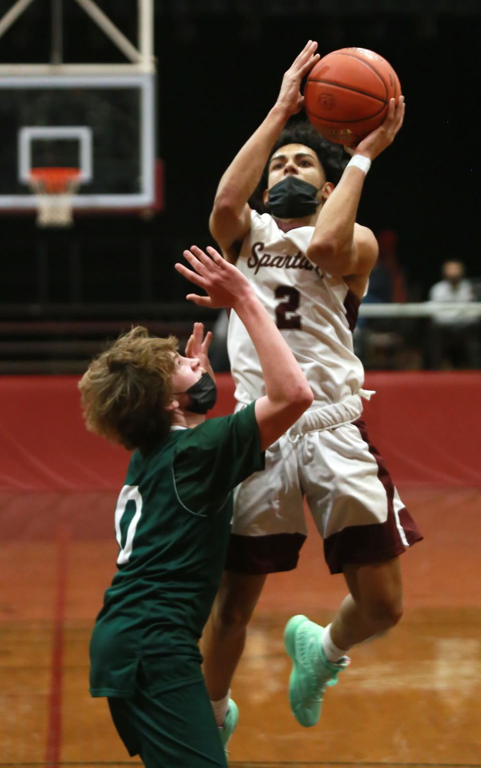 Luis Vega Jr. gets the jump on Aiden Smith on the short jumper Friday in Bishop Stang's 63-49 win over Dartmouth at the John C. O'Brien Gymnasium.