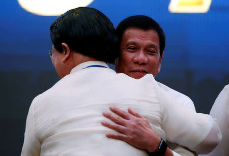 President Rodrigo Duterte hugs an unidentified businessman during a meeting in Pasay city, Metro Manila, Philippines, October 13, 2016. REUTERS/Erik De Castro