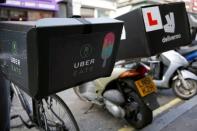 An UberEATS food delivery bike is seen parked next to a Deliveroo scooter in London, Britain September 7, 2016. REUTERS/Neil Hall