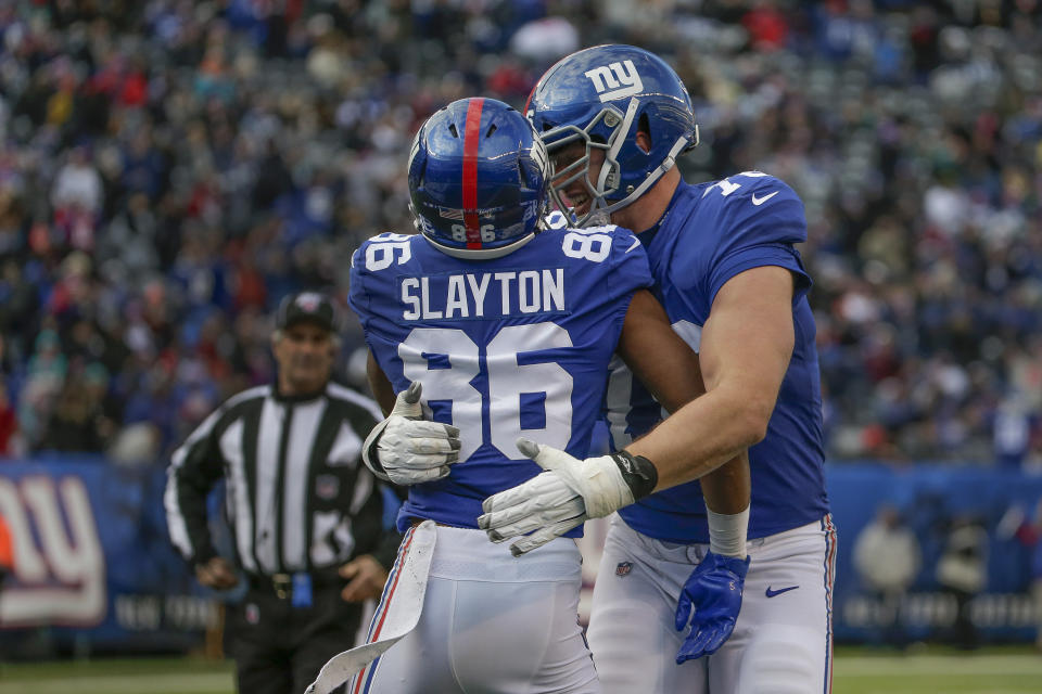 New York Giants wide receiver Darius Slayton (86) celebrates with offensive tackle Nate Solder (76) after scoring a touchdown against the Miami Dolphins during the third quarter of an NFL football game, Sunday, Dec. 15, 2019, in East Rutherford, N.J. (AP Photo/Seth Wenig)