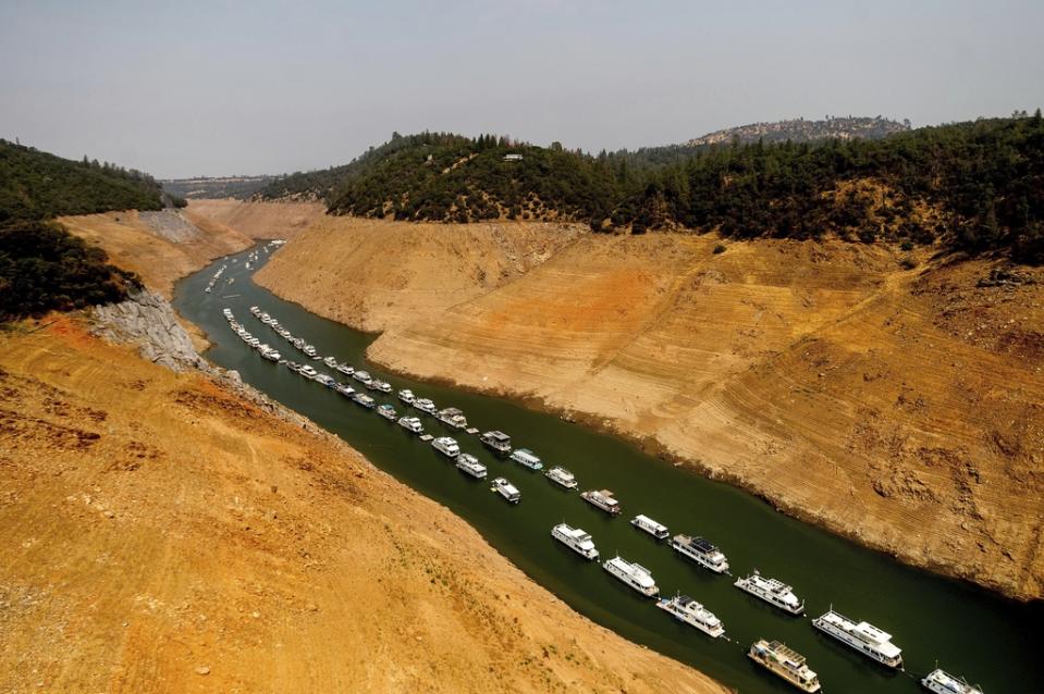 FILE – Houseboats rest in a channel at Lake Oroville State Recreation Area in Butte County, Calif., on Aug. 14, 2021. Months of winter storms have replenished California’s key reservoirs after three years of punishing drought. (AP Photo/Noah Berger, File)