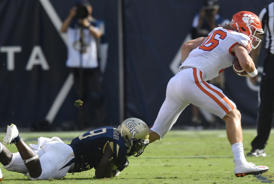 Georgia Tech linebacker Victor Alexander (9) tackles Clemson quarterback Trevor Lawrence (16) during the first half of an NCAA college football game, Saturday, Sept. 22, 2018, in Atlanta. (AP Photo/Mike Stewart)