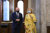 Sen. Mark Kelly, D-Ariz., is joined by Cindy McCain, right, the widow of the late Senator John McCain of Arizona, as Kelly arrives to deliver his maiden speech to the Senate, at the Capitol in Washington, Wednesday, Aug. 4, 2021. (AP Photo/J. Scott Applewhite)