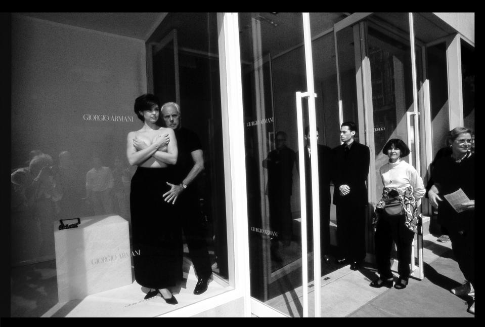 Giorgio Armani and Ashley Judd in the window of the Armani boutique on Madison Avenue in New York. Photographed for U.S. Vogue.