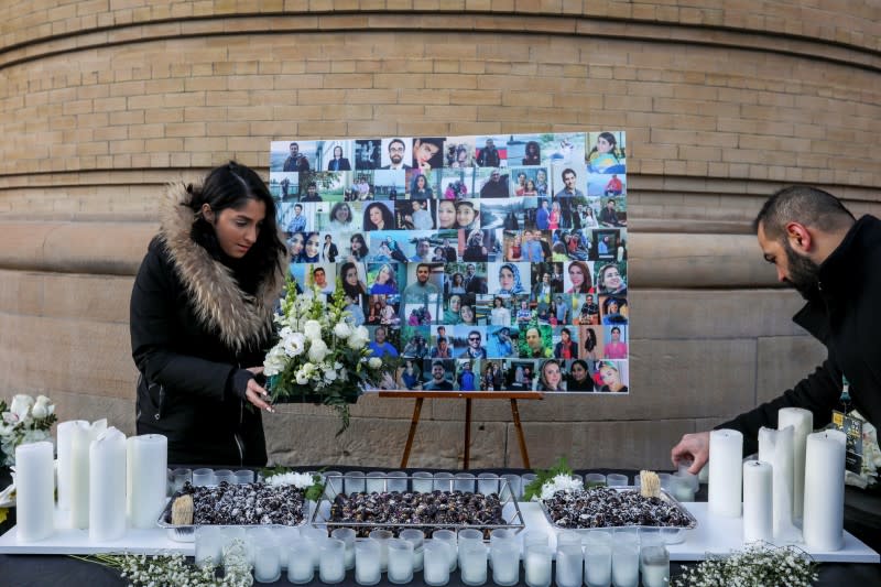 Mourners attend a memorial for the victims of a Ukrainian passenger plane which was shot down in Iran