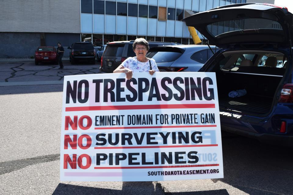 Betty Strom, a local landowner and opponent to Summit Carbon Solutions' CO2 pipeline, stands in the parking lot after the Minnehaha County Commission meeting with a "No Trespassing" sign on Tuesday, August 2, 2022.