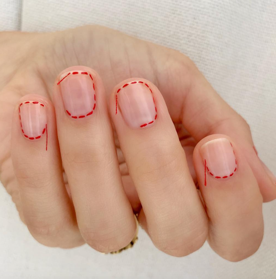Copy nail artist Betina Goldstein and glue leftover string from a sewing kit at the ends of your “stitches” to play up the creepy Coraline vibes.