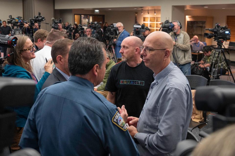 Club Q owners Matthew Haynes, right, and Nic Grzecka, center right, speak with Colorado Springs Police Chief Adrian Vasquez after a press conference on the shooting in Colorado Springs, Colorado, on Monday, Nov. 21, 2022.