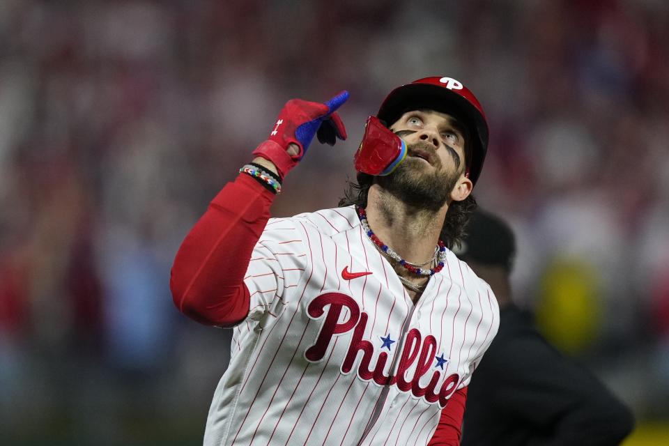 Philadelphia Phillies' Bryce Harper reacts after hitting a home run during the fifth inning of Game 3 of a baseball NL Division Series against the Atlanta Braves Wednesday, Oct. 11, 2023, in Philadelphia. (AP Photo/Matt Rourke)