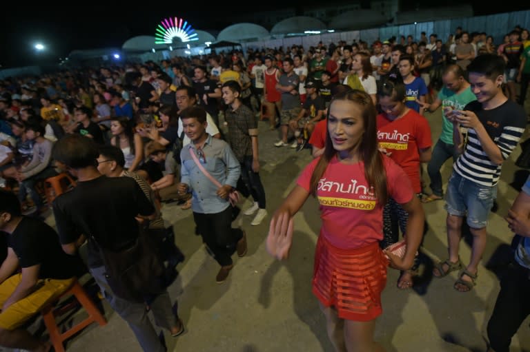 Members of the audience from the Isaan region, the heartland of the "Red Shirt" movement loyal to the elected government toppled by the military, dance while Mo Lam singers perform on stage in Bangkok