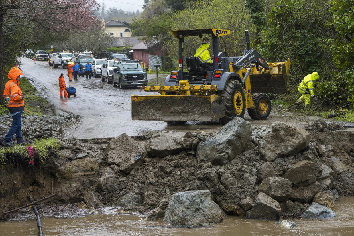 Crews assess storm damage, which washed out North Main Street in Soquel, Calif., Friday, March 10, 2023. (AP Photo/Nic Coury)